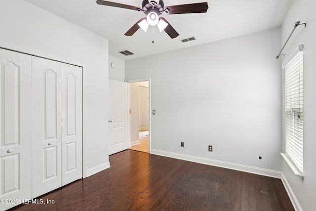 741 W Kings College Dr, Saint Johns, FL 32259 - unfurnished bedroom featuring dark wood-style floors, multiple windows, a closet, and ceiling fan