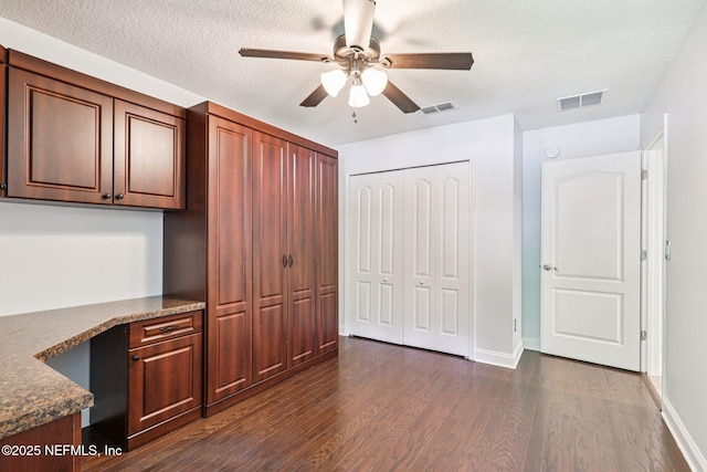 741 W Kings College Dr, Saint Johns, FL 32259 - unfurnished bedroom with dark wood-type flooring, a closet, a textured ceiling, and ceiling fan