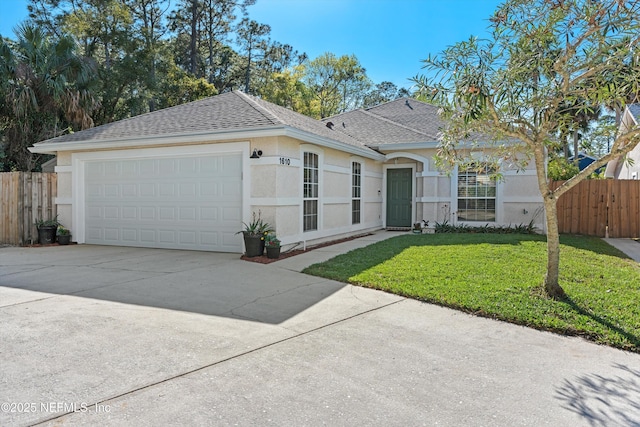 single story home featuring a front lawn, fence, roof with shingles, stucco siding, and an attached garage