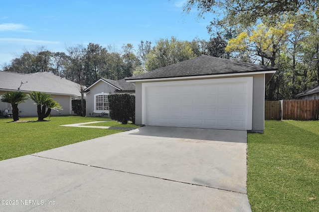 view of front of home with a garage, a front yard, fence, and stucco siding