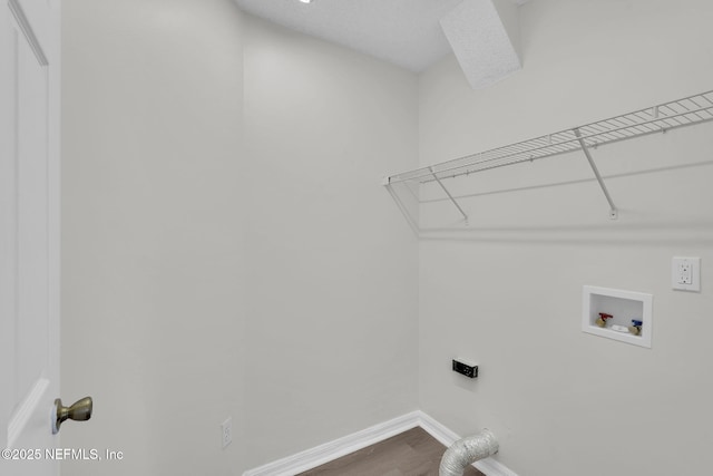 washroom featuring hookup for an electric dryer, laundry area, dark wood-type flooring, washer hookup, and baseboards