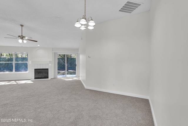 unfurnished living room with a wealth of natural light, carpet flooring, visible vents, and baseboards