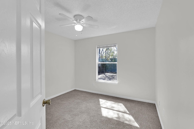 empty room with ceiling fan, carpet floors, a textured ceiling, and baseboards