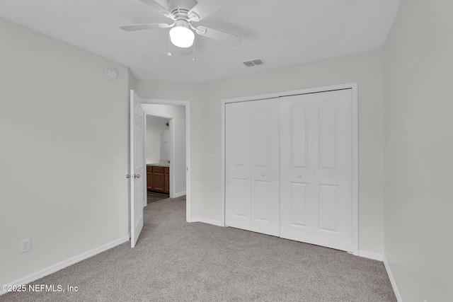 unfurnished bedroom featuring carpet, a closet, visible vents, and baseboards