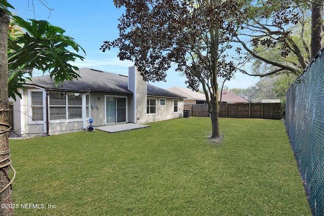 view of yard featuring central AC unit and a fenced backyard