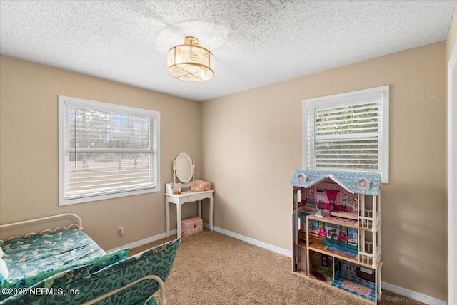 carpeted bedroom with baseboards and a textured ceiling