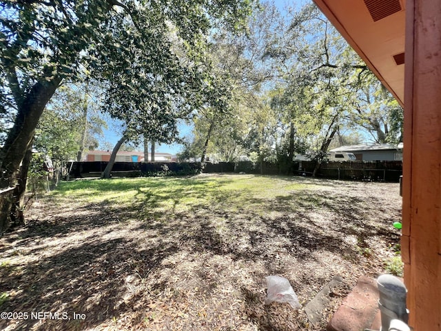 view of yard featuring a fenced backyard and visible vents