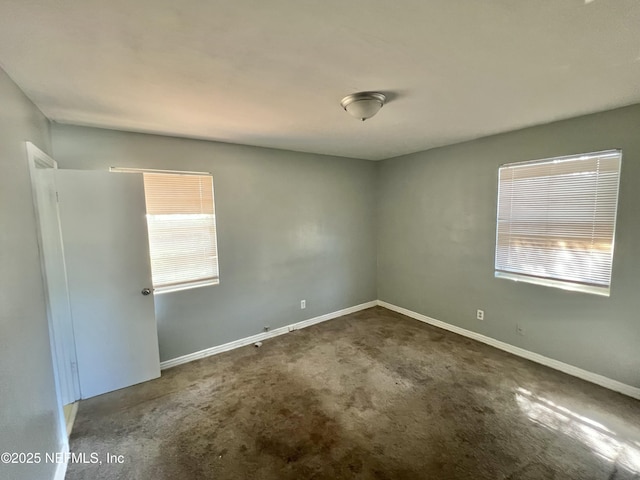 carpeted spare room with baseboards