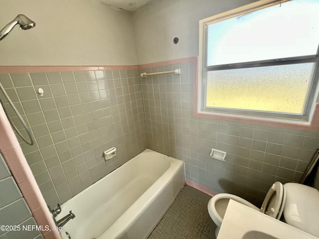 full bath featuring wainscoting, tile walls, toilet, and tile patterned floors