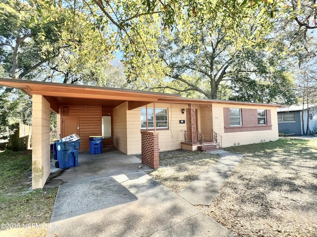 ranch-style house with a carport and driveway