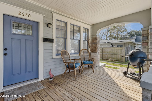 deck with covered porch, fence, and grilling area