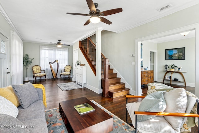 living room with stairs, wood finished floors, visible vents, and crown molding