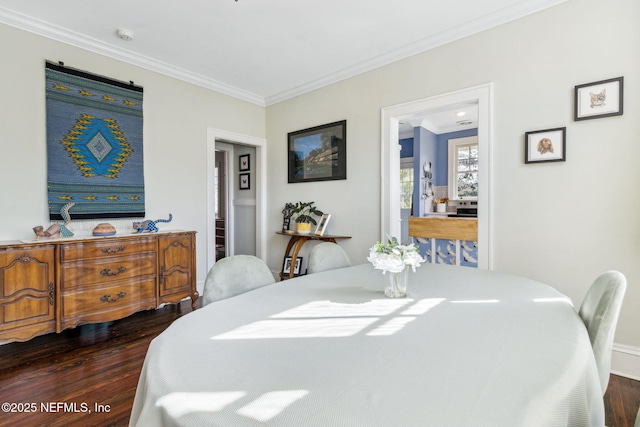 dining room featuring crown molding and dark wood-style flooring