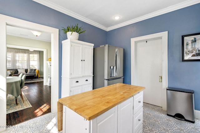 kitchen featuring wood counters, white cabinetry, stainless steel refrigerator with ice dispenser, light wood finished floors, and crown molding