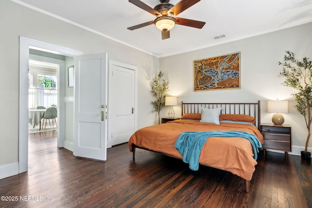 bedroom with ornamental molding, visible vents, and wood finished floors