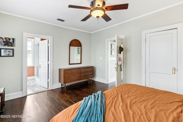 bedroom with visible vents, crown molding, baseboards, and wood finished floors