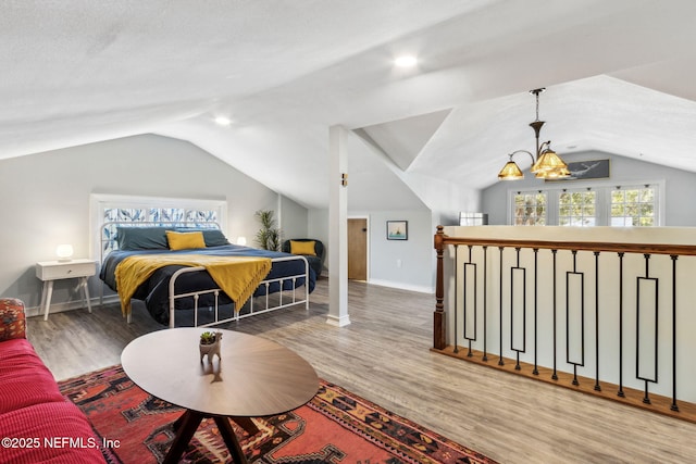 bedroom featuring vaulted ceiling, baseboards, and wood finished floors