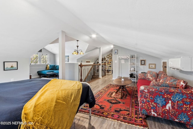 bedroom with vaulted ceiling and wood finished floors