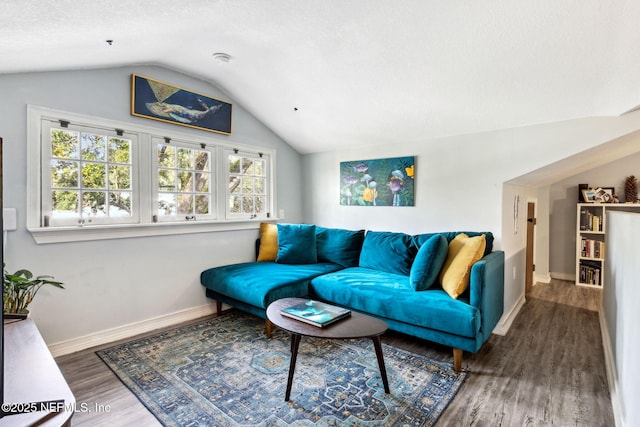 living room featuring baseboards, vaulted ceiling, and wood finished floors