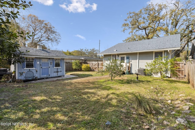 view of yard with an outbuilding and a fenced backyard