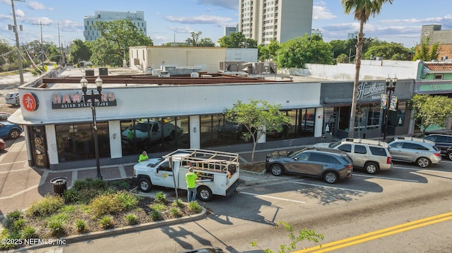 view of property featuring uncovered parking and a city view