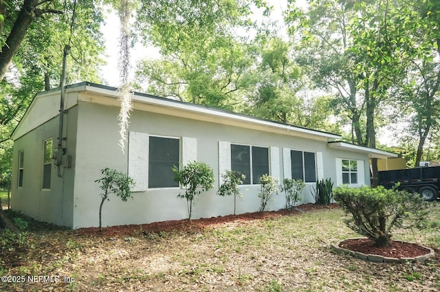 view of side of home with stucco siding