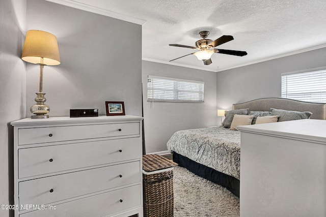 bedroom with a ceiling fan, baseboards, ornamental molding, and a textured ceiling