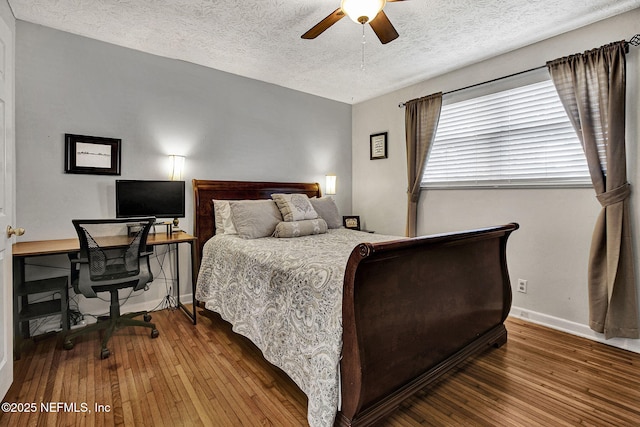 bedroom with wood-type flooring, baseboards, ceiling fan, and a textured ceiling