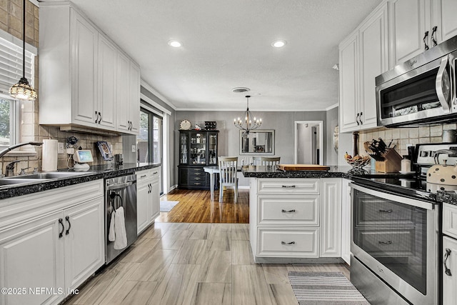 kitchen with white cabinetry, appliances with stainless steel finishes, and a sink