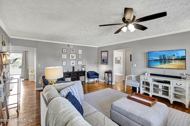 living area featuring crown molding, visible vents, ceiling fan, wood finished floors, and baseboards