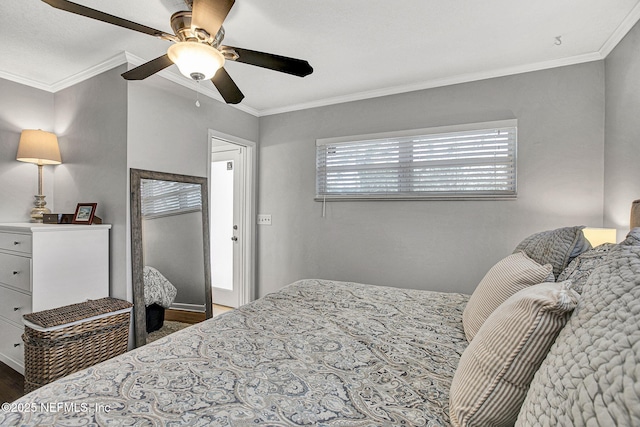 bedroom featuring ceiling fan, wood finished floors, and crown molding