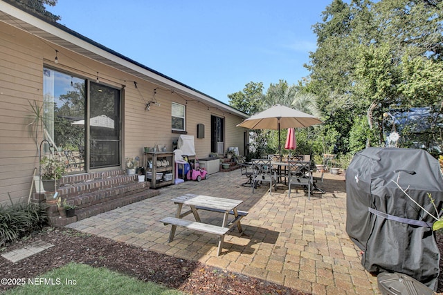 view of patio / terrace featuring entry steps, outdoor dining space, and area for grilling