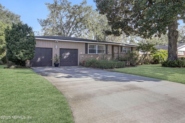 ranch-style house with a garage, a front yard, concrete driveway, and brick siding