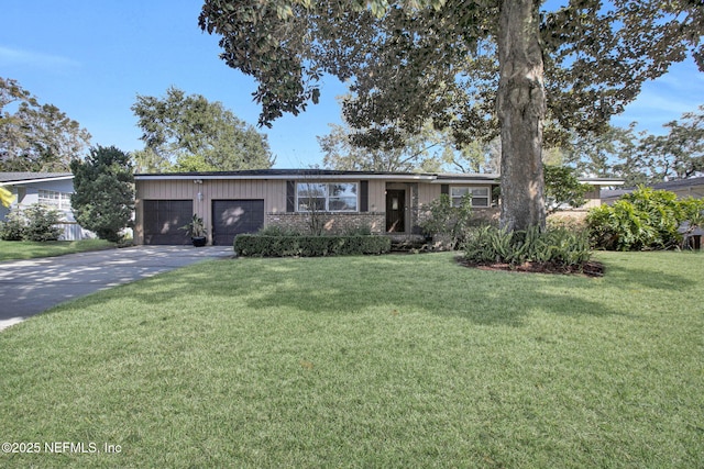 view of front facade featuring a garage, concrete driveway, brick siding, and a front yard