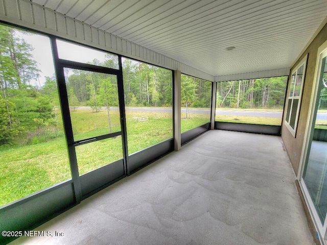 unfurnished sunroom with plenty of natural light