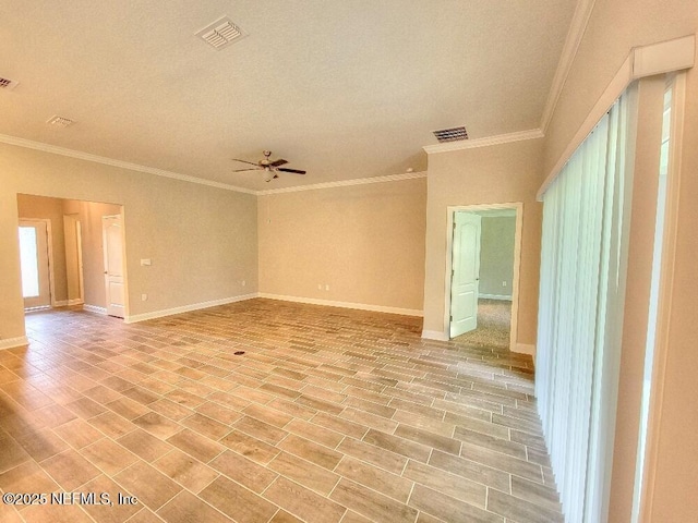 unfurnished room with ceiling fan, visible vents, and baseboards