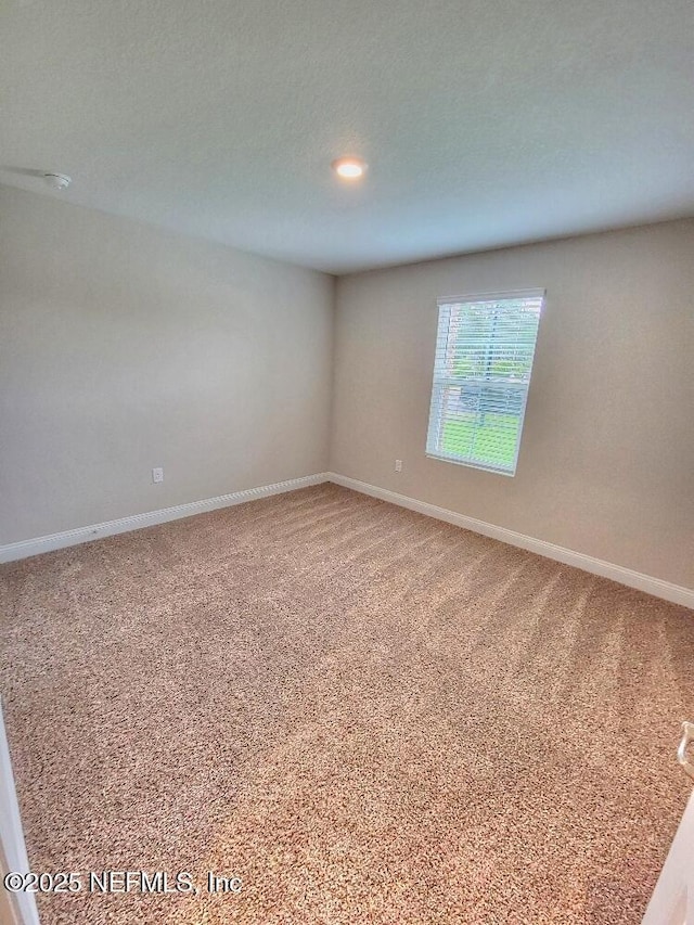 spare room with carpet floors and baseboards