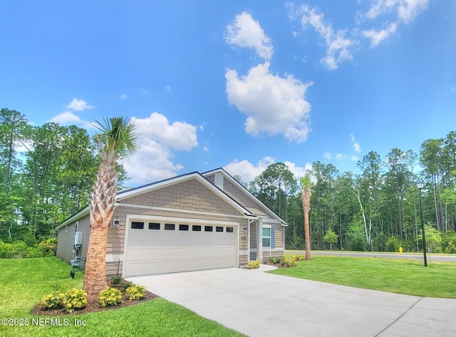 view of front of home featuring a garage, concrete driveway, and a front yard