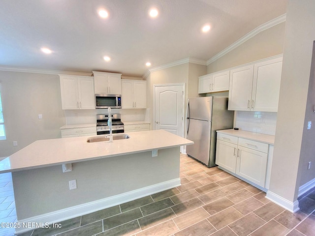 kitchen with white cabinetry, stainless steel appliances, and a sink