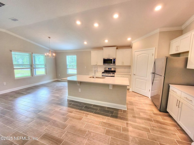 kitchen with stainless steel appliances, light countertops, white cabinets, a sink, and a chandelier