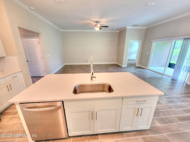 kitchen with open floor plan, light countertops, stainless steel dishwasher, and a sink