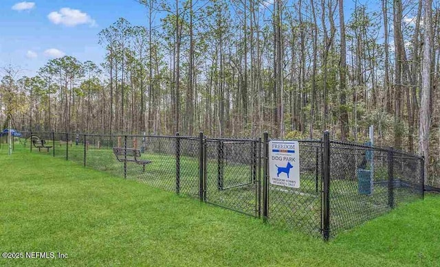 exterior space with fence and a yard