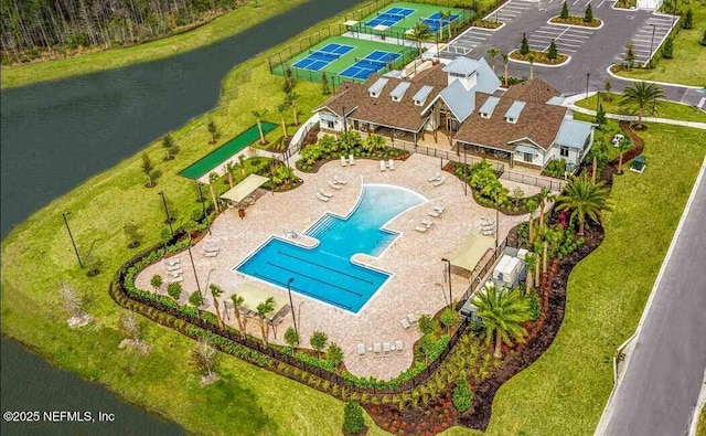 view of swimming pool with a water view and a patio area