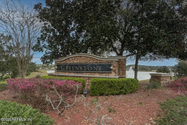 community sign with a water view