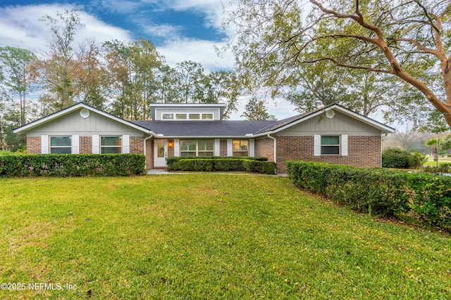 view of front of property with a front yard and brick siding