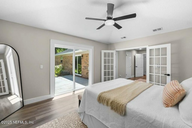 bedroom with baseboards, visible vents, wood finished floors, access to exterior, and french doors