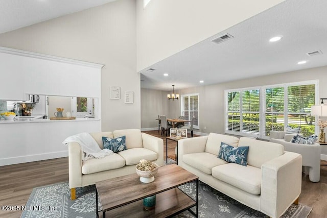 living area featuring recessed lighting, visible vents, and wood finished floors