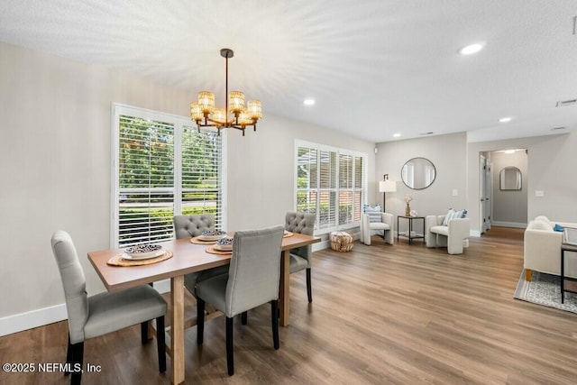 dining area featuring recessed lighting, wood finished floors, and baseboards