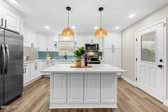 kitchen with light countertops, appliances with stainless steel finishes, and white cabinets