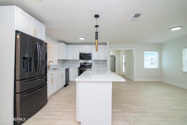 kitchen with decorative backsplash, electric stove, dishwashing machine, light countertops, and black fridge